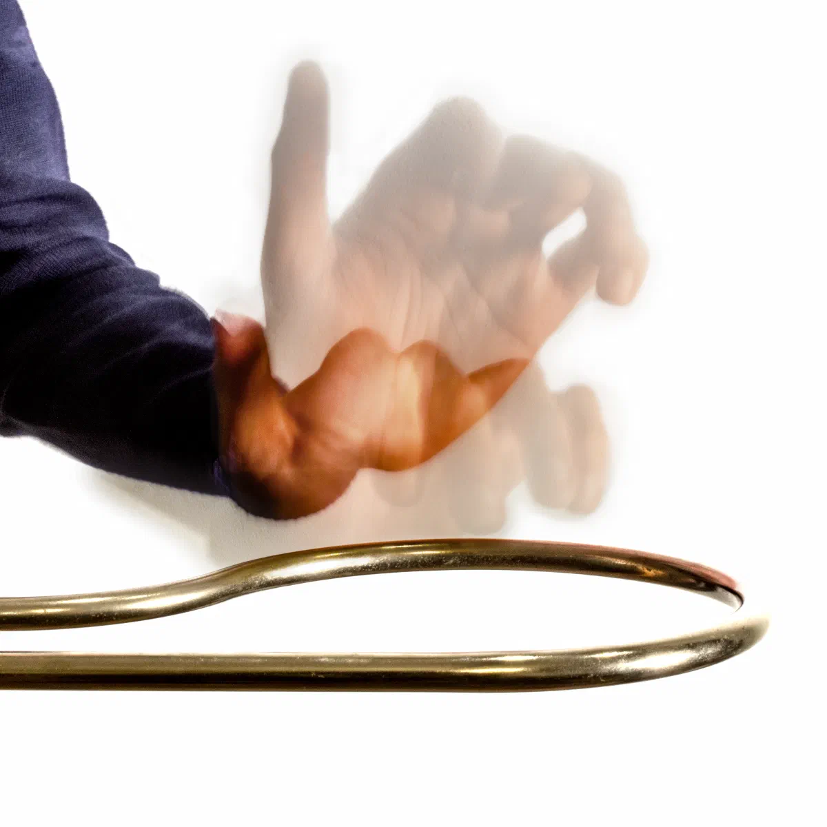 A hand moves up and down above the theremin's horizontal loop-shaped volume antenna